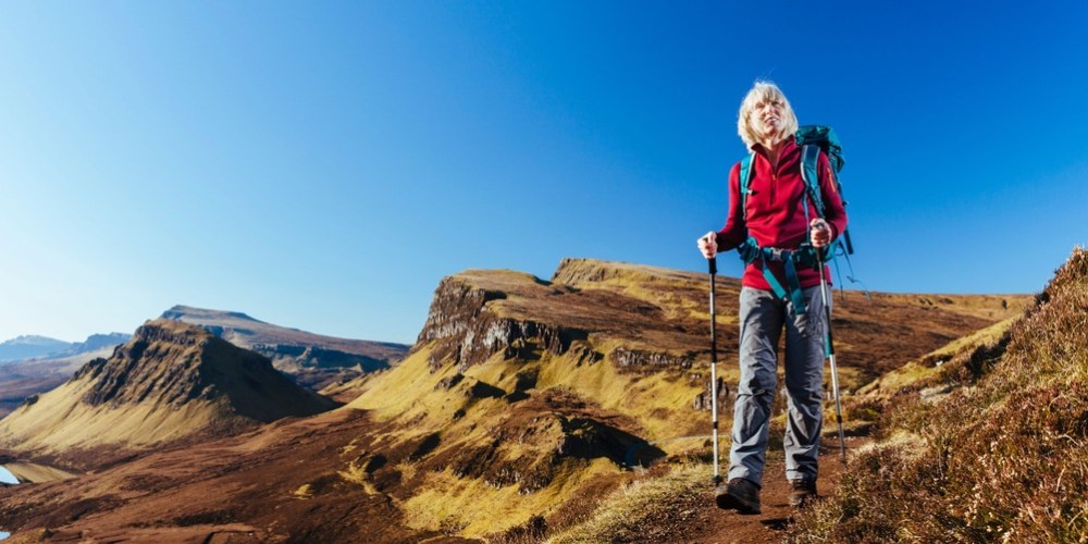 a woman standing on a rocky hill