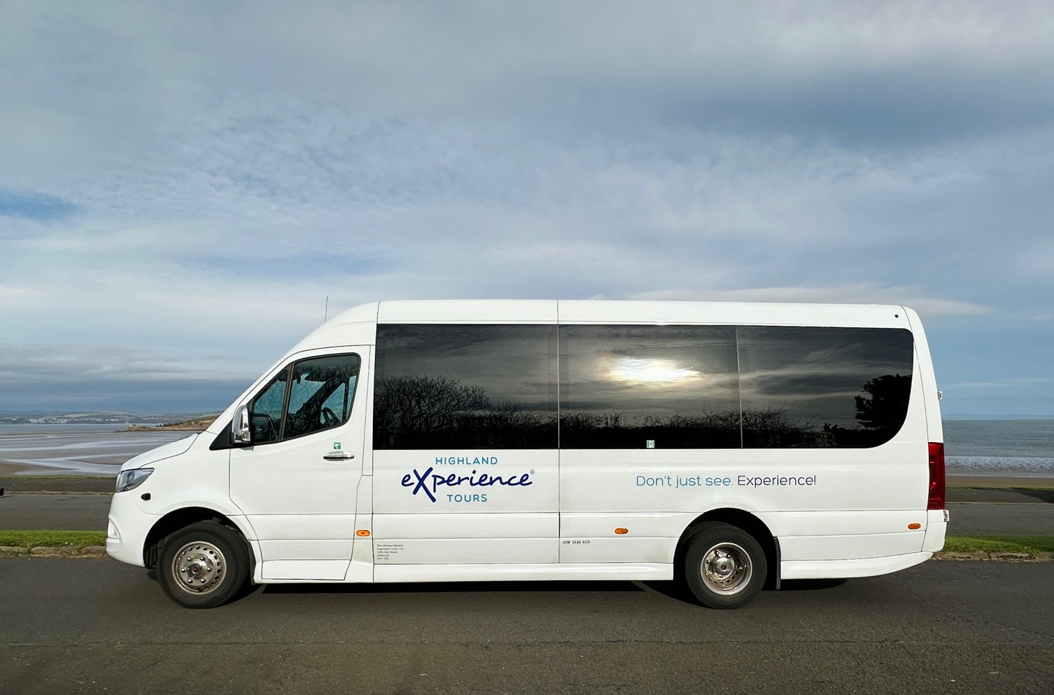 a van parked in front of a bus