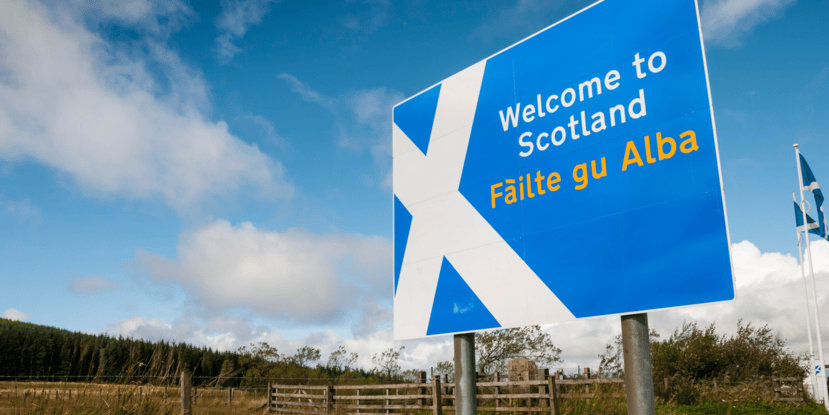 a sign in front of a cloudy blue sky